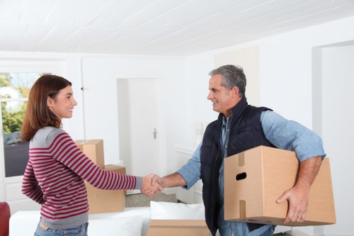 Professional movers handling desks and office items carefully